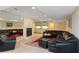 Spacious basement recreation room with a fireplace, wet bar, and sectional sofa at 1120 Heards Ferry Rd, Sandy Springs, GA 30328