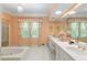 Bathroom with double vanity, jetted tub, and hexagonal tile floor at 1120 Heards Ferry Rd, Sandy Springs, GA 30328