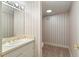 Small half bathroom with a pedestal sink and toilet at 1120 Heards Ferry Rd, Sandy Springs, GA 30328