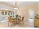 Elegant dining room with a glass-top table and four chairs, adjacent to the kitchen at 1120 Heards Ferry Rd, Sandy Springs, GA 30328