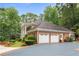 Brick home with two-car garage and mature trees at 1120 Heards Ferry Rd, Sandy Springs, GA 30328