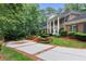 Two-story brick home with a large driveway and landscaping at 1120 Heards Ferry Rd, Sandy Springs, GA 30328