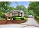Brick home with circular driveway and manicured lawn at 1120 Heards Ferry Rd, Sandy Springs, GA 30328