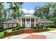 Brick home with columns, lush landscaping, and brick driveway at 1120 Heards Ferry Rd, Sandy Springs, GA 30328