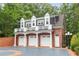 Three-car garage with brick exterior and ample parking space at 1120 Heards Ferry Rd, Sandy Springs, GA 30328