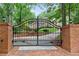 Ornate black gate with brick pillars leading to home at 1120 Heards Ferry Rd, Sandy Springs, GA 30328