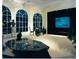 Elegant home theater with large projection screen, comfortable seating, and ample natural light at 1120 Heards Ferry Rd, Sandy Springs, GA 30328