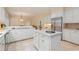 Open kitchen boasting white cabinetry, a sizable island, and stainless steel appliances at 1120 Heards Ferry Rd, Sandy Springs, GA 30328