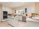 Spacious kitchen featuring white cabinets, stainless steel appliances, and a large island at 1120 Heards Ferry Rd, Sandy Springs, GA 30328