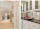 Convenient wet bar with granite countertop, sink, and glass-front cabinets at 1120 Heards Ferry Rd, Sandy Springs, GA 30328