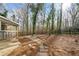 Private backyard with mature trees and stone patio at 240 Dogwood Dr, Canton, GA 30114