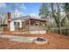 Secluded backyard with a stone firepit and screened porch at 240 Dogwood Dr, Canton, GA 30114