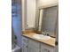 Bathroom featuring a vanity with a framed mirror and a shower-tub combination at 240 Dogwood Dr, Canton, GA 30114