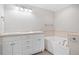 Bright bathroom featuring a soaking tub, double sink vanity, and decorative lighting at 240 Dogwood Dr, Canton, GA 30114