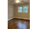 Bright bedroom with a ceiling fan, large windows, and beautiful hardwood floors at 240 Dogwood Dr, Canton, GA 30114