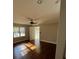 Cozy bedroom with ceiling fan, natural light from windows, and hardwood flooring at 240 Dogwood Dr, Canton, GA 30114