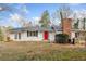 Charming home with brick chimney, red front door and a metal roof at 240 Dogwood Dr, Canton, GA 30114