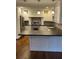 Bright kitchen with white cabinets, stainless steel appliances, and an island at 240 Dogwood Dr, Canton, GA 30114