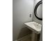 Powder room featuring a pedestal sink with decorative mirror and modern fixtures at 240 Dogwood Dr, Canton, GA 30114