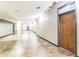 Long hallway with concrete floors and exposed pipes at 805 Peachtree St # 515, Atlanta, GA 30308