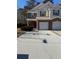 Two-story brick and vinyl townhome with a two-car garage and well-manicured lawn at 101 Ellis Dr # 101, Conyers, GA 30012