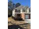 Two-story brick and vinyl townhome with a two-car garage and landscaping at 101 Ellis Dr # 101, Conyers, GA 30012