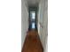 Long hallway with wood flooring and multiple doors leading to bedrooms at 101 Ellis Dr # 101, Conyers, GA 30012