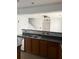Kitchen boasts double sink, dark countertops, and wood cabinets at 101 Ellis Dr # 101, Conyers, GA 30012