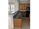 Kitchen features dark countertops, wood cabinets, and a breakfast bar at 101 Ellis Dr # 101, Conyers, GA 30012