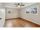 Spacious bedroom with hardwood floors, ceiling fan, and multiple windows at 148 Walker Nw Rd, Cartersville, GA 30121