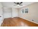 Bright bedroom with hardwood floors, built-in shelving, and ceiling fan at 148 Walker Nw Rd, Cartersville, GA 30121