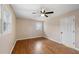 Well-lit bedroom, hardwood floors, ceiling fan, and neutral wall tones at 148 Walker Nw Rd, Cartersville, GA 30121
