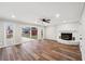 Gathering room with wood-look flooring, fireplace, and sliding glass doors at 148 Walker Nw Rd, Cartersville, GA 30121