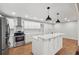 Modern kitchen featuring white cabinets, stainless steel appliances, and a large island at 148 Walker Nw Rd, Cartersville, GA 30121