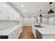 Modern kitchen with white cabinets, quartz countertops, and hardwood floors at 148 Walker Nw Rd, Cartersville, GA 30121