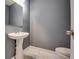 Modern powder room with pedestal sink and marble flooring at 6269 Colonial Vw, Fairburn, GA 30213