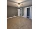 Gray-walled bedroom with carpet and double doors at 6269 Colonial Vw, Fairburn, GA 30213