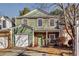Two-story townhome with green siding, stone accents, and a two-car garage at 6269 Colonial Vw, Fairburn, GA 30213