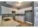 Modern kitchen with white cabinets, quartz countertops, and double sink at 6269 Colonial Vw, Fairburn, GA 30213