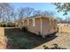 Side view of a tan brick ranch house with mature trees in the background at 2182 Loring Ct, Decatur, GA 30032