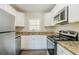 Modern kitchen with granite countertops and stainless steel appliances at 2182 Loring Ct, Decatur, GA 30032