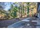 Large backyard with a concrete patio and mature trees at 93 Sterling Ridge Dr, Jonesboro, GA 30238