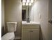 Simple bathroom with a white vanity, toilet, and mirror at 93 Sterling Ridge Dr, Jonesboro, GA 30238