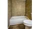 Bathroom featuring tile surround and a white toilet and bathtub at 93 Sterling Ridge Dr, Jonesboro, GA 30238