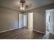 Spacious bedroom with wood-look flooring, ceiling fan, and access to multiple rooms at 93 Sterling Ridge Dr, Jonesboro, GA 30238