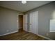 Well-lit bedroom with wood-look floors and two closets, offering ample space at 93 Sterling Ridge Dr, Jonesboro, GA 30238