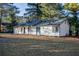 White house exterior with a spacious yard and mature trees at 93 Sterling Ridge Dr, Jonesboro, GA 30238
