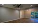 Bright living room with hardwood floors, ceiling fan, and sliding glass doors at 93 Sterling Ridge Dr, Jonesboro, GA 30238