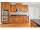 Modern kitchen featuring double ovens, granite countertops, and wood cabinets at 3356 Renfro St, Marietta, GA 30066