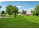 Expansive backyard with manicured lawn, mature trees, and outdoor seating, perfect for entertaining at 4450 Millenium View Ct, Snellville, GA 30039
